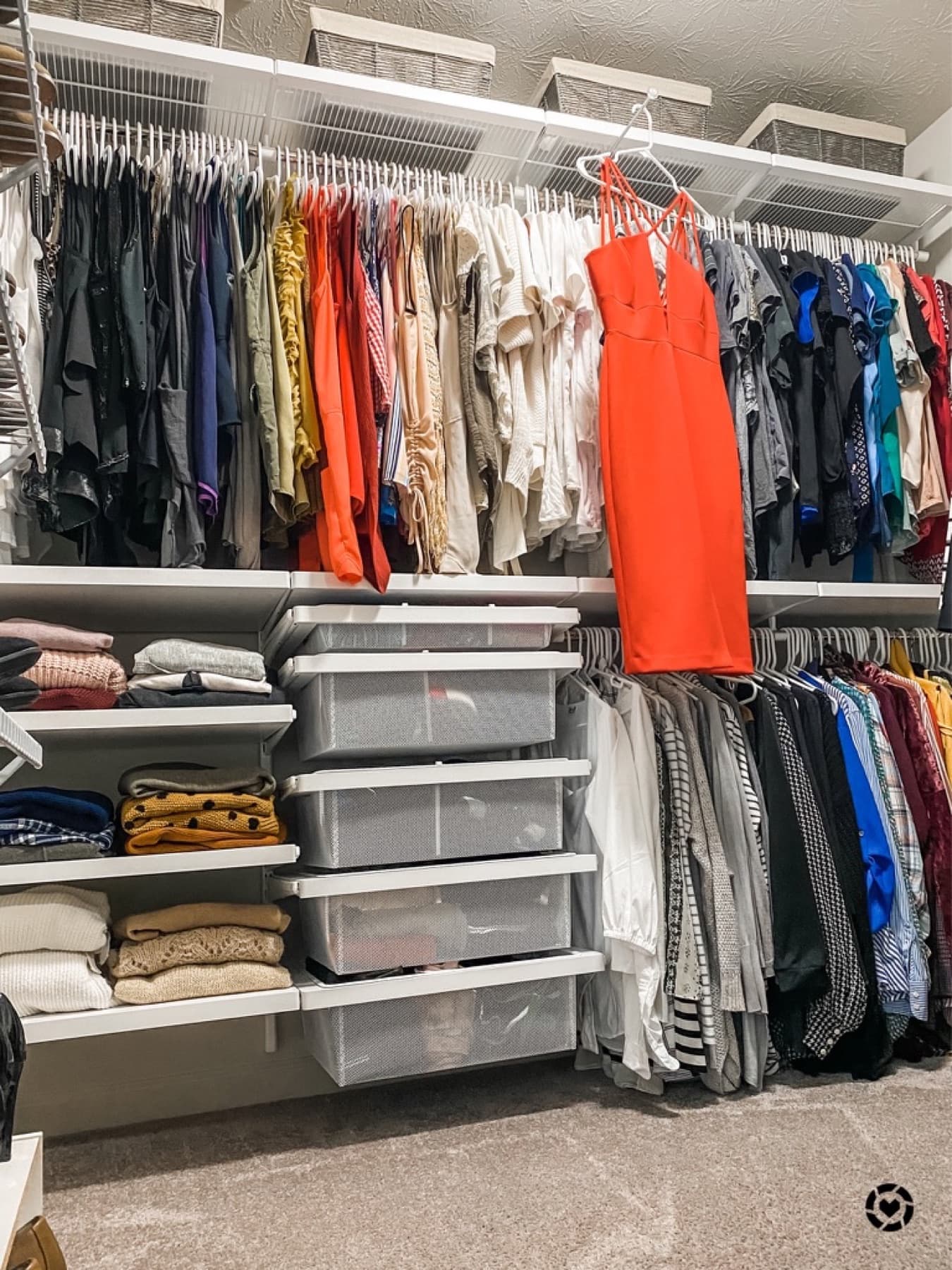 A reworked closet with clothes hung and folded by zone and clear drawer storage.