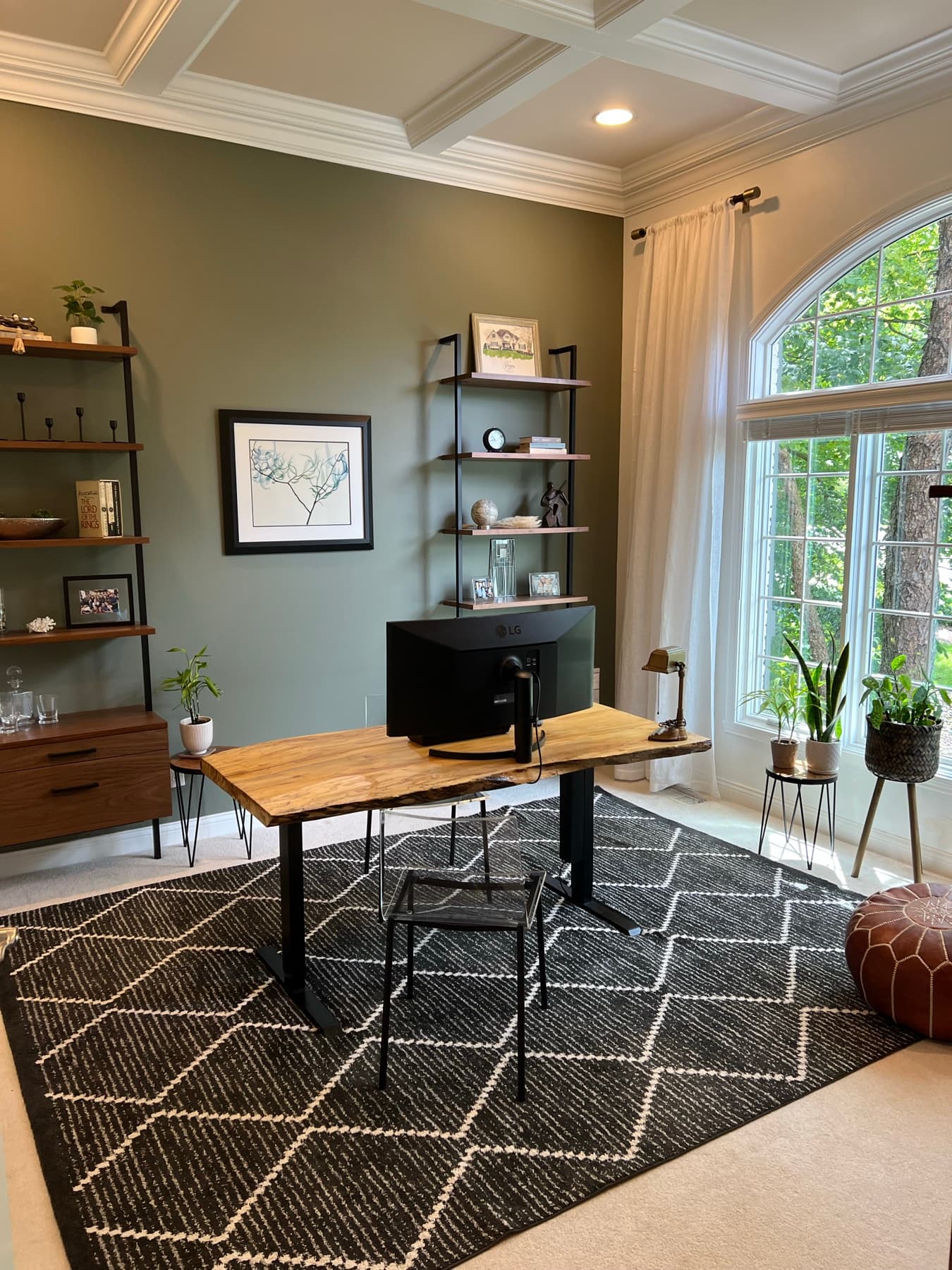 A styled corner vignette of wood, brass, and green.
